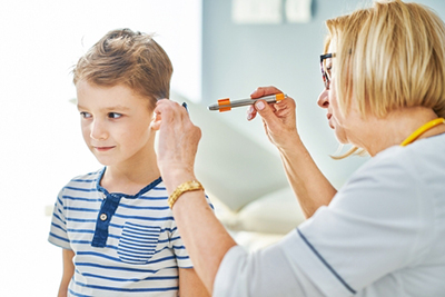 ENT doctor examining child's ear infection