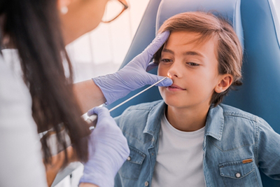 Child having nasal examination with ENT specialist